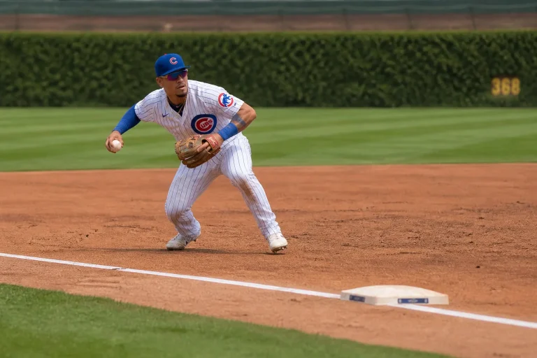 MLB infielder fielding a ground ball at shortstop and setting up to throw across the diamond