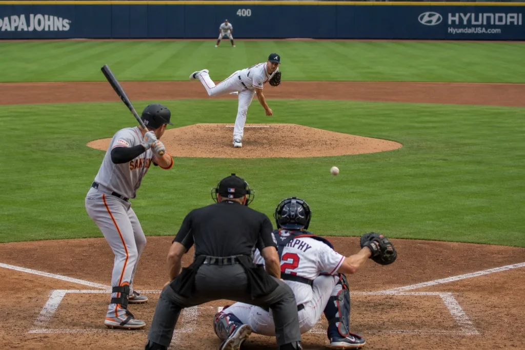 MLB starting pitcher delivering a sharp slider with the catcher framing the pitch on the outside corner